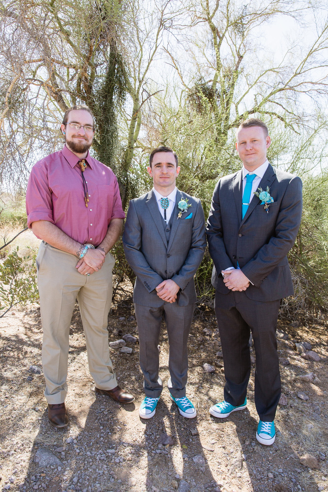 Grey and turquoise groomsmen and officiant in the Arizona desert by wedding photography by PMA Photography.
