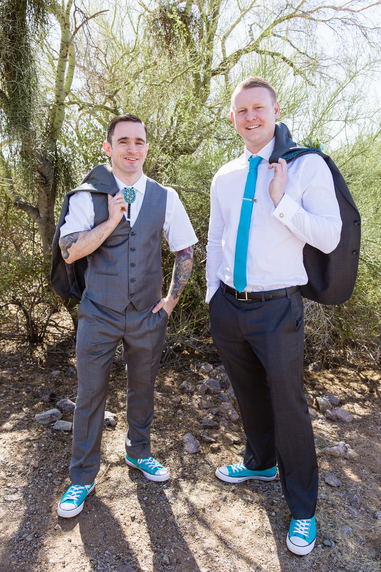 Grey and turquoise groom and groomsman in converse in the Arizona desert by wedding photography by PMA Photography.
