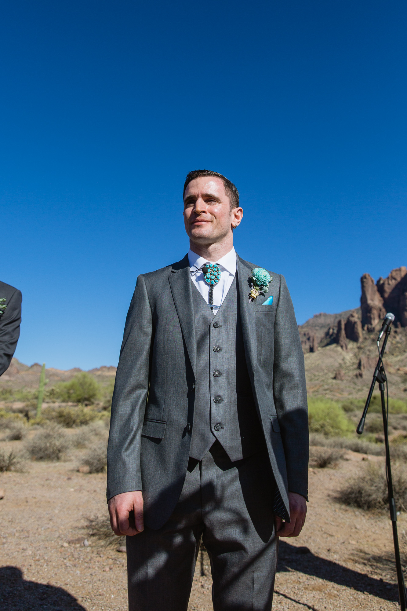 Groom seeing his bride walk down the aisle at Lost Dutchman State Park by Arizona photographers PMA Photography.