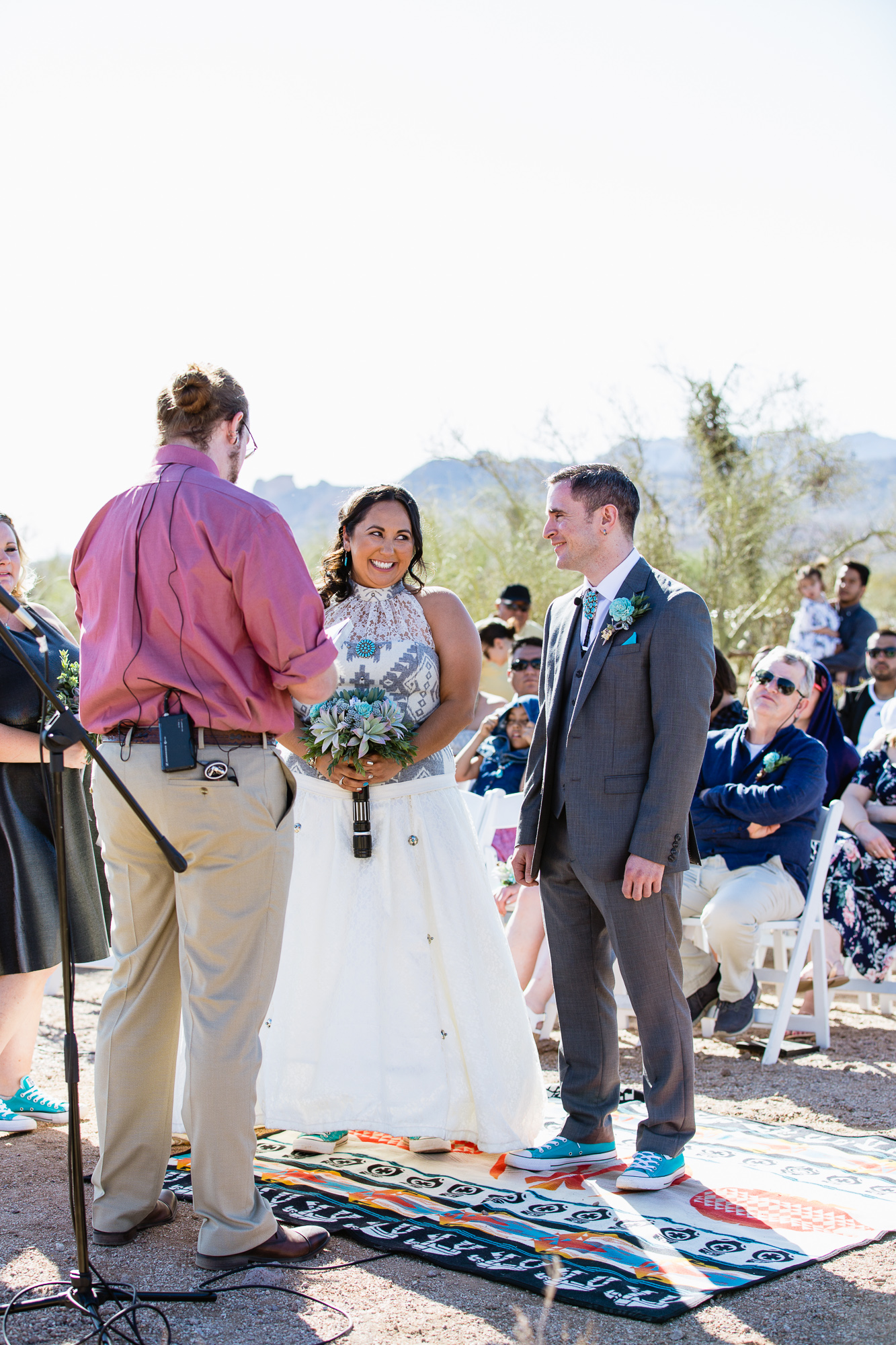Bride and groom sharing a laugh during their Lost Dutchman State Park wedding ceremony by Arizona wedding photographer PMA Photography.