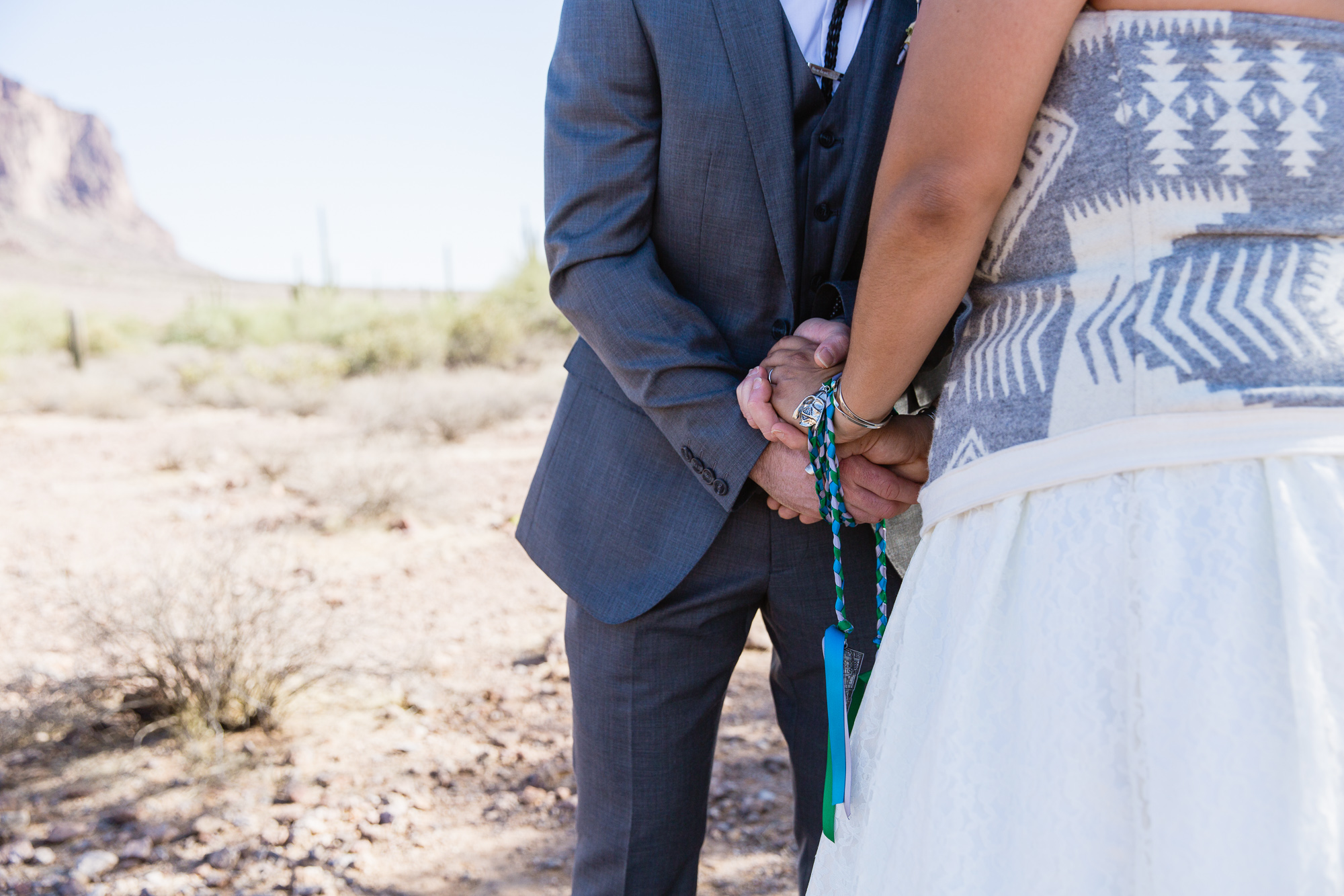 Bride and grooms hands fastened with Star Wars themed handfasting chords by Arizona wedding photographers PMA Photography.