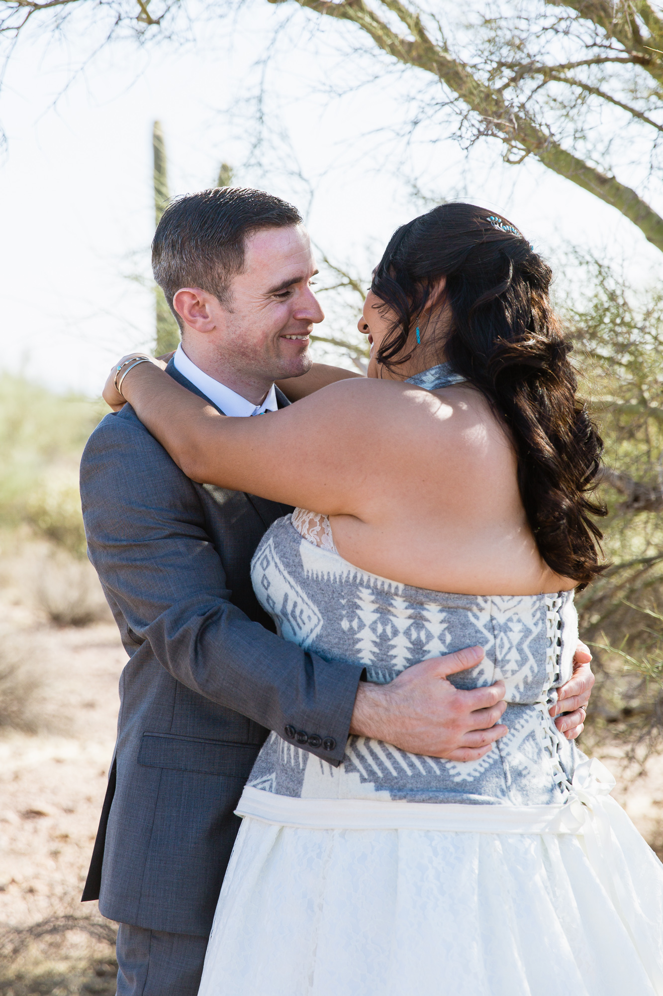 Bride and groom at their Lost Dutchman State Park wedding by Arizona wedding photographers PMA Photography.