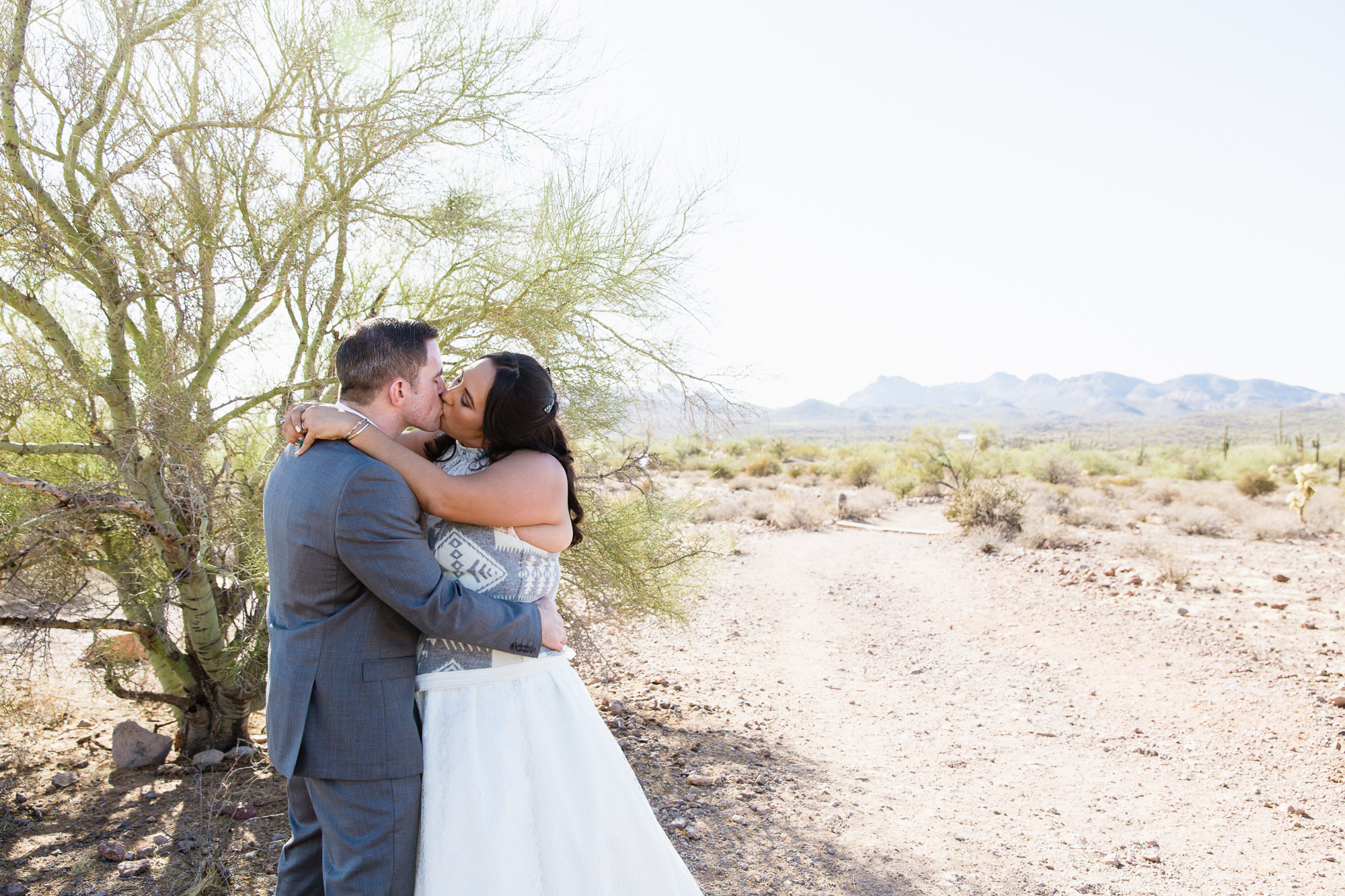 Bride and groom at their Lost Dutchman State Park wedding by Arizona wedding photographers PMA Photography.