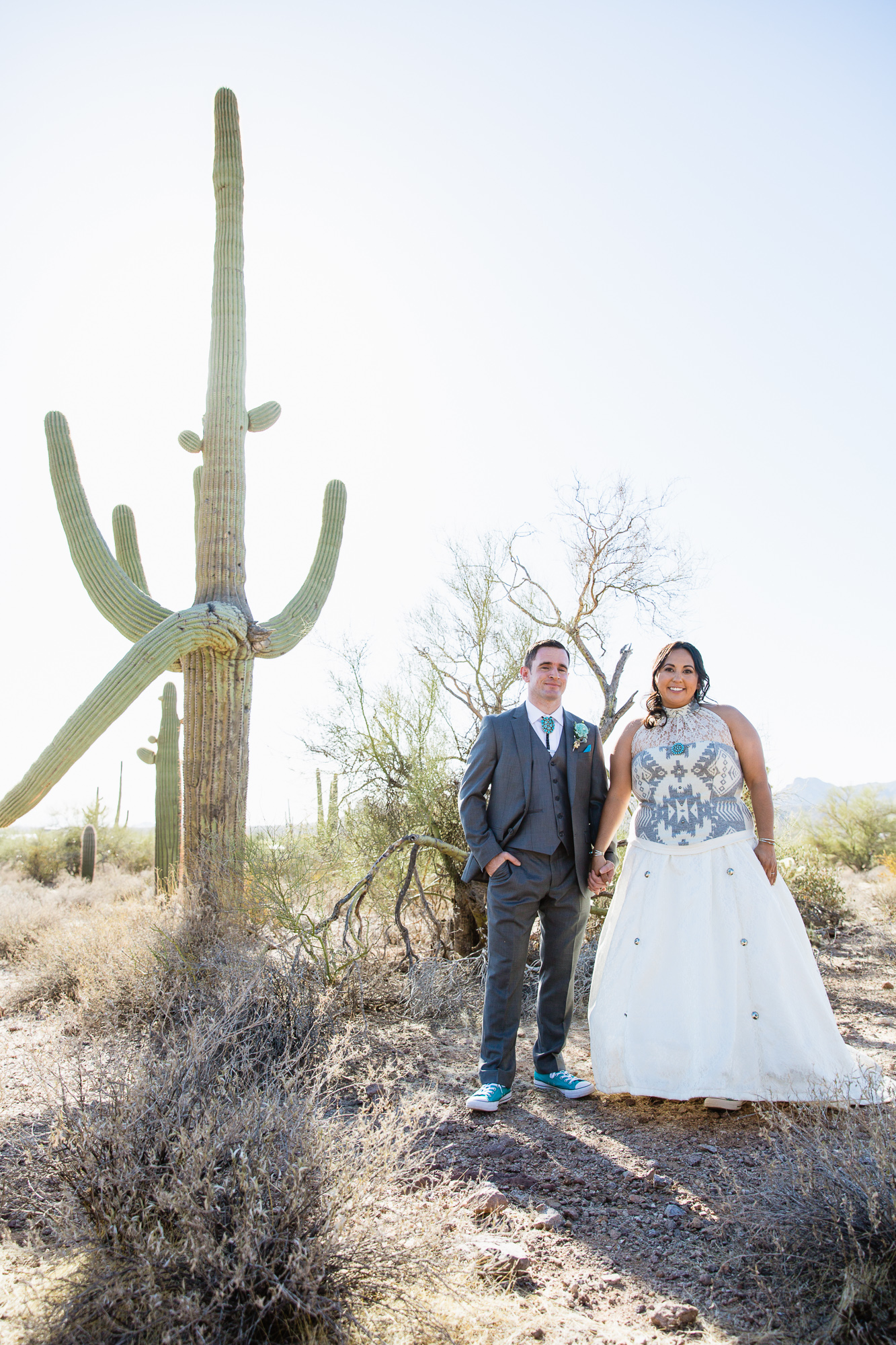 Bride and groom in the Arizona desert at their Lost Dutchman State Park wedding by Arizona wedding photographers PMA Photography.