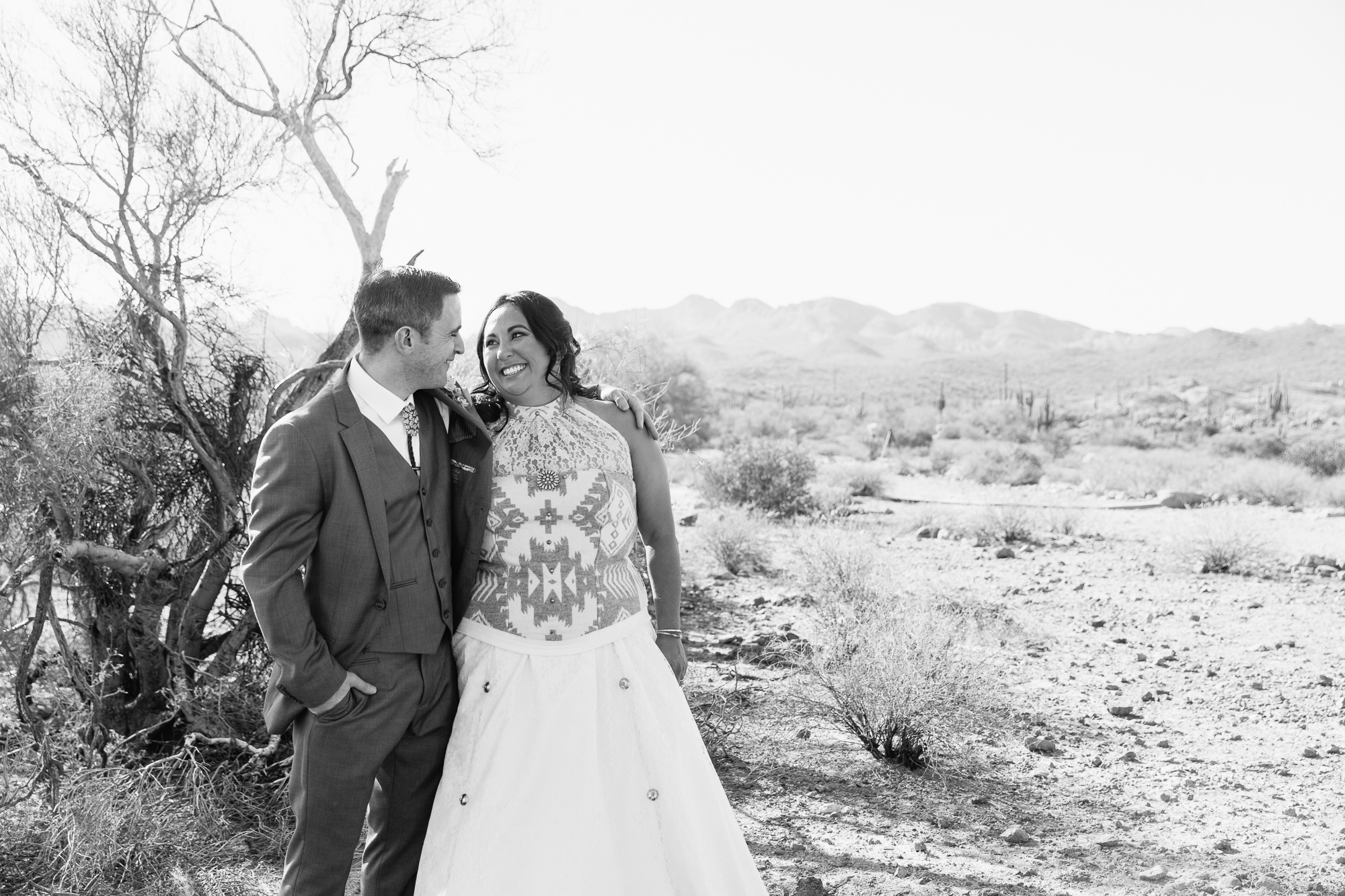 Black and white image of Bride and groom at their Lost Dutchman State Park wedding by Arizona wedding photographers PMA Photography.