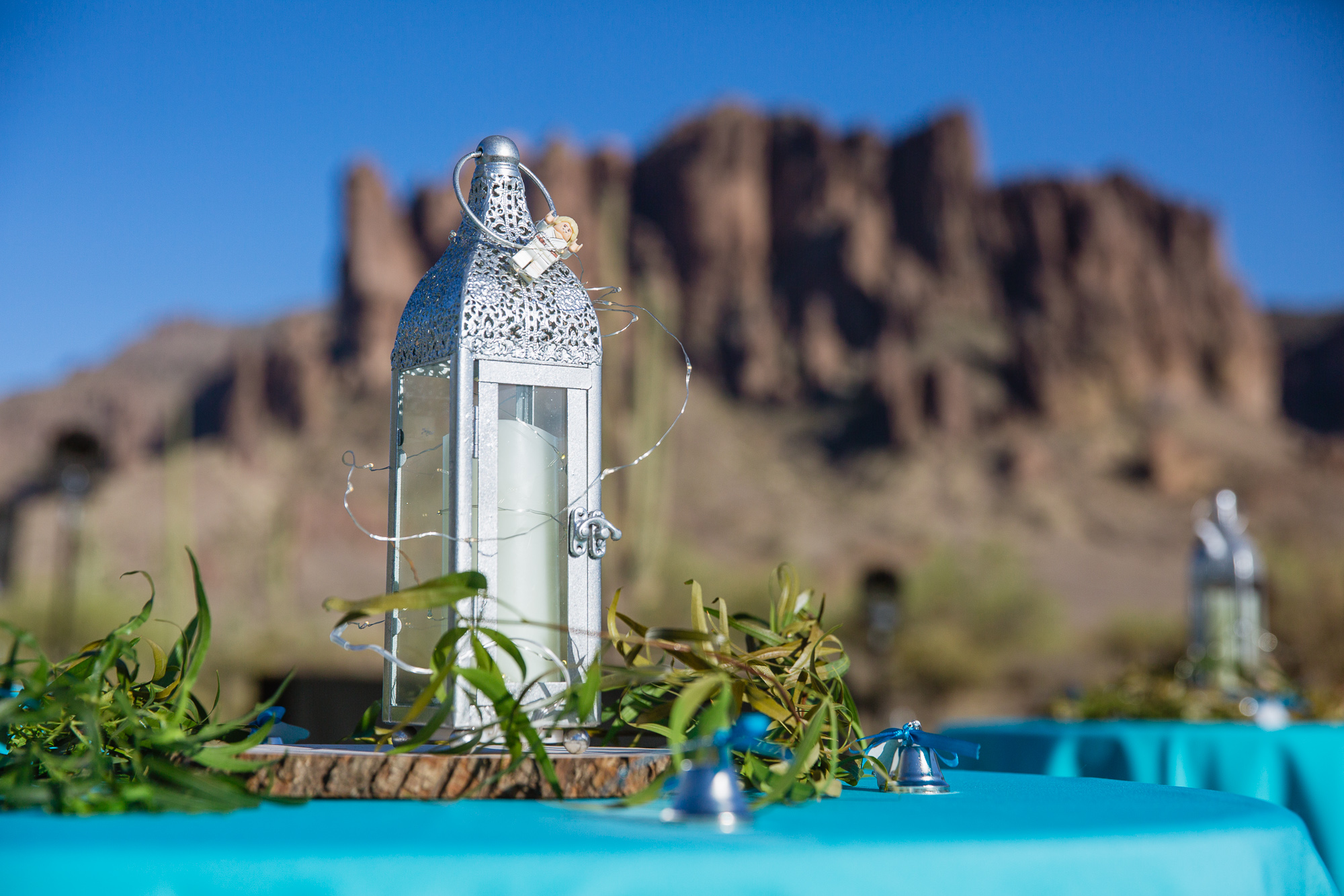 Simple wedding lantern and Star Wars lego centerpiece with Irish bell favors at a Lost Dutchman State Park wedding by Arizona wedding photographer PMA Photography.