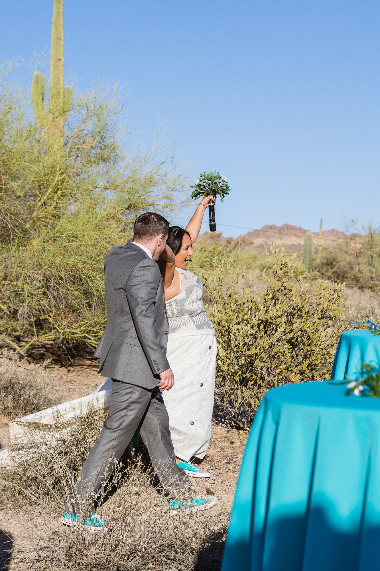 Bride and groom entering to the reception by Arizona wedding photographer PMA Photography.