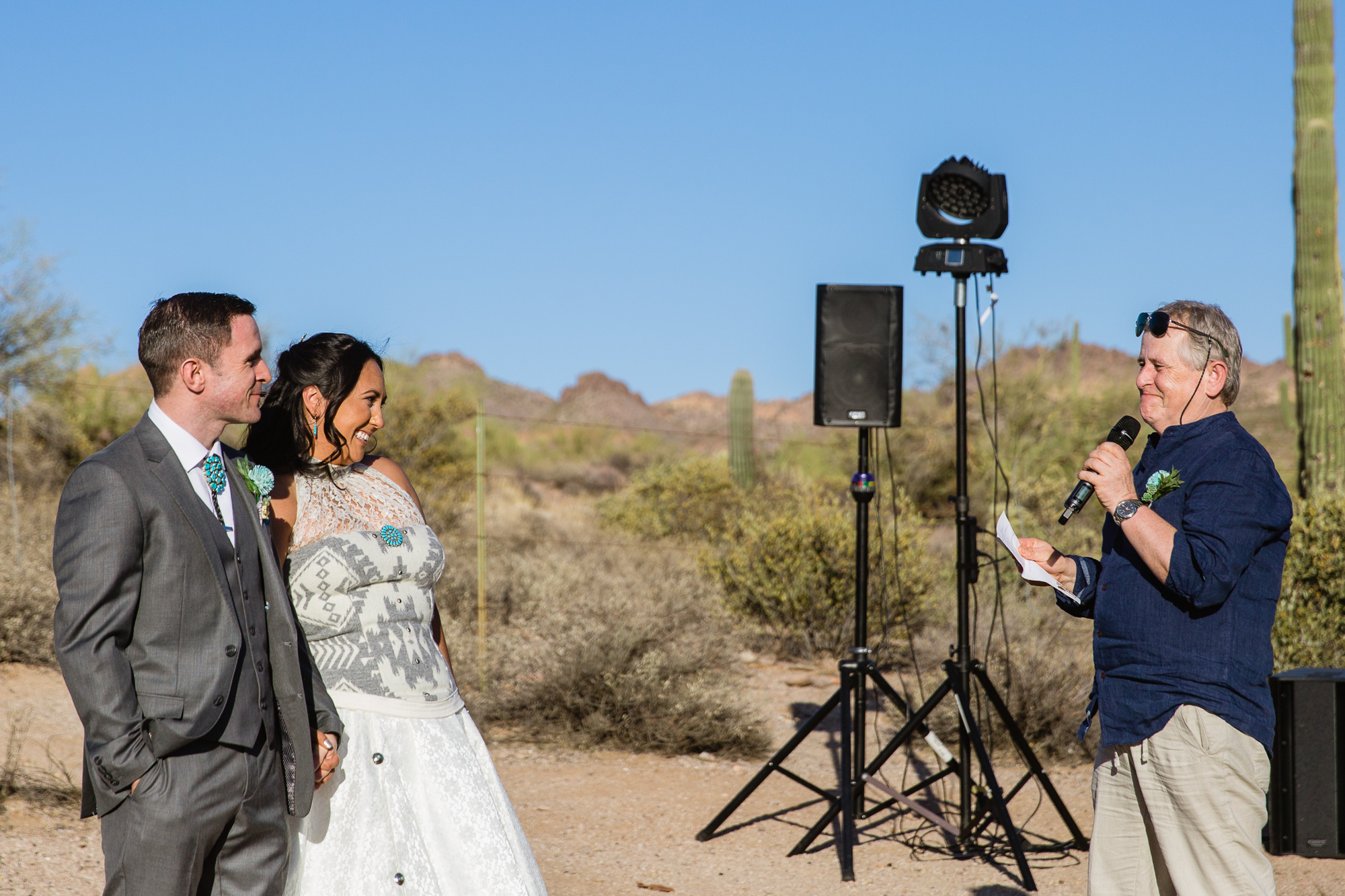 Groom's father giving a toast at the wedding reception at Lost Dutchman State Park by Arizona wedding photographer PMA Photography.
