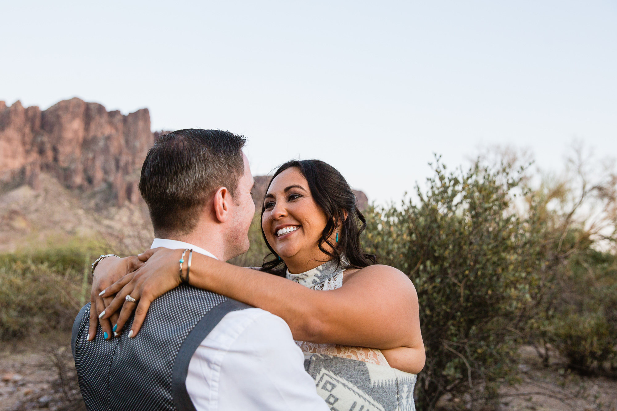 Bride looking at her groom at the superstition mountains at Lost Dutchman state park by Arizona wedding photographer PMA Photography.