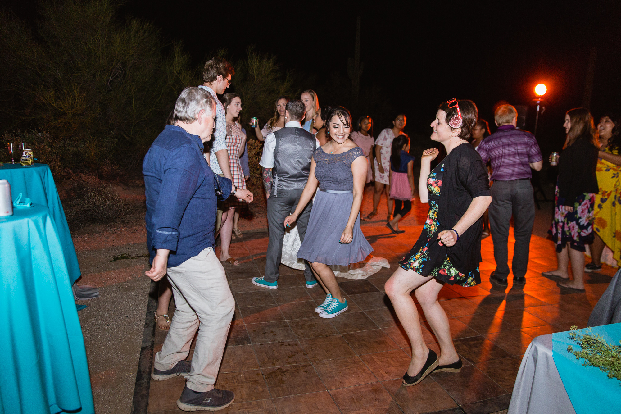 Guests dancing at a wedding reception by Arizona wedding photographer PMA Photography.