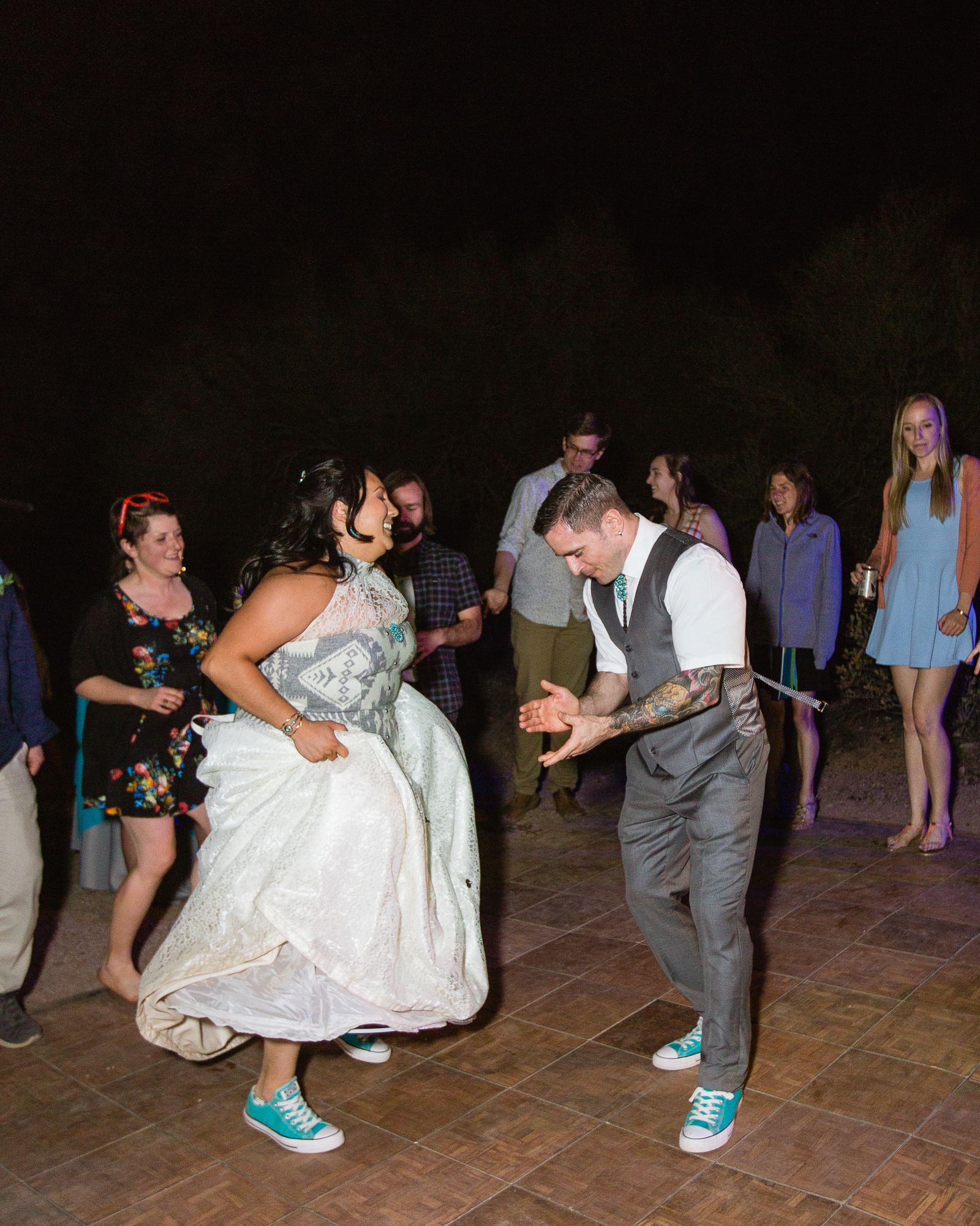 Bride and groom dancing with guests to an Irish song at their wedding reception by Arizona wedding photographer PMA Photography.