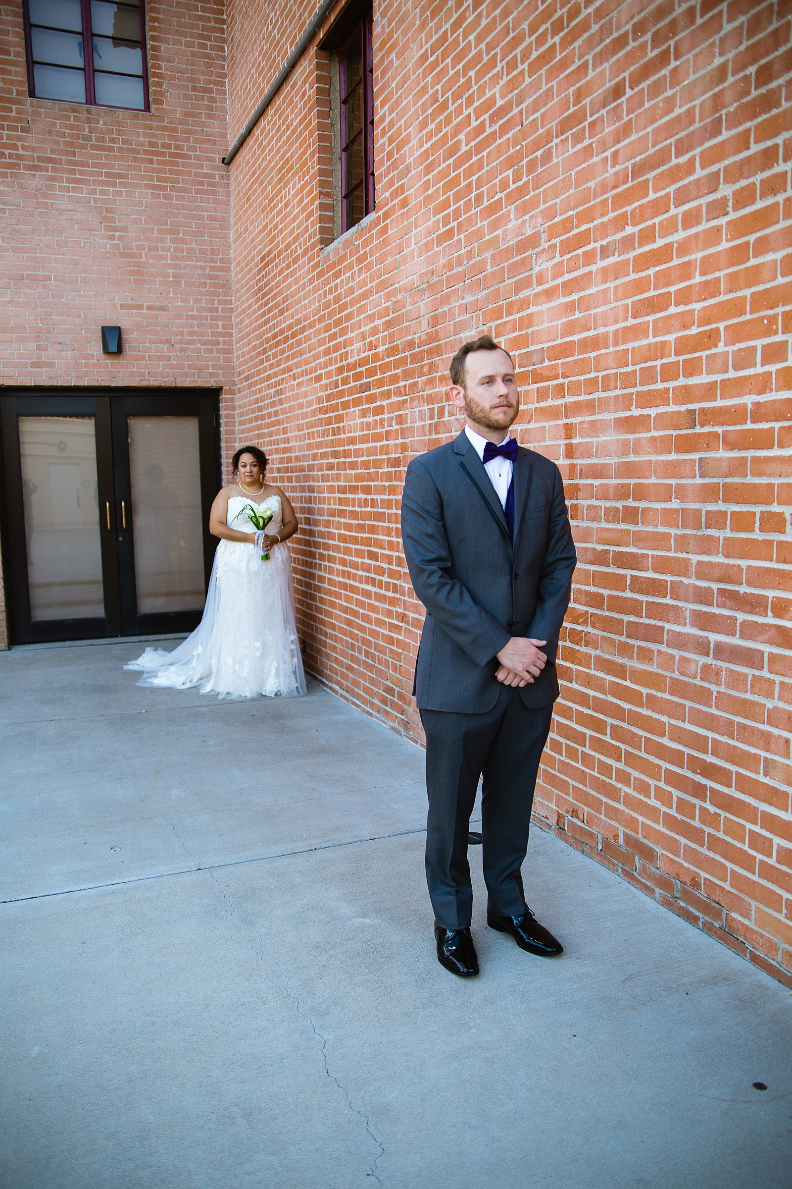 Bride and groom's first look at Encanto Park by Arizona wedding photographer PMA Photography.