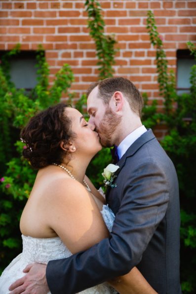Bride and groom share a kiss during their Encanto Park wedding by Phoenix wedding photographer PMA Photography.