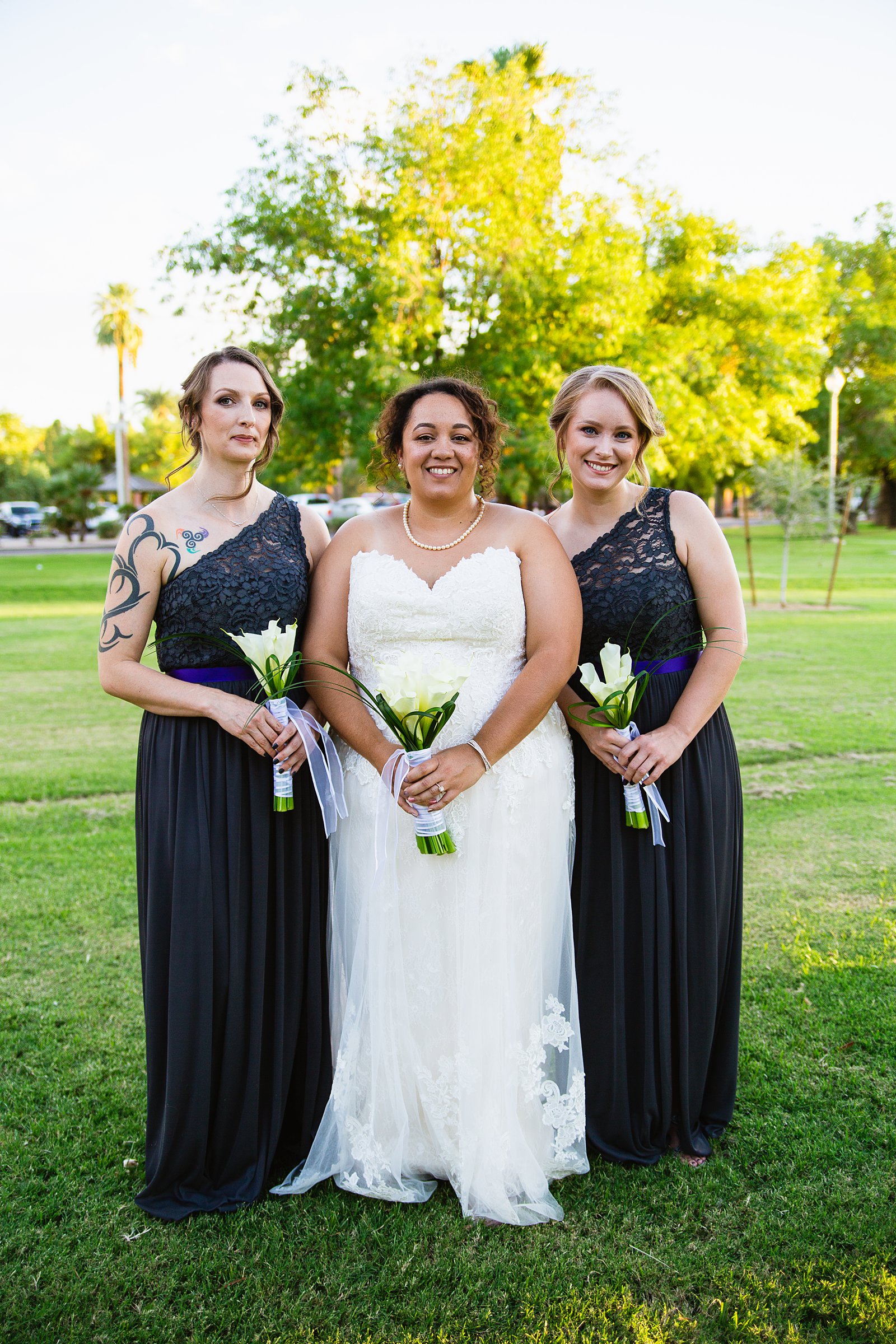 Bride and bridesmaids together at a Encanto Park wedding by Arizona wedding photographer PMA Photography.
