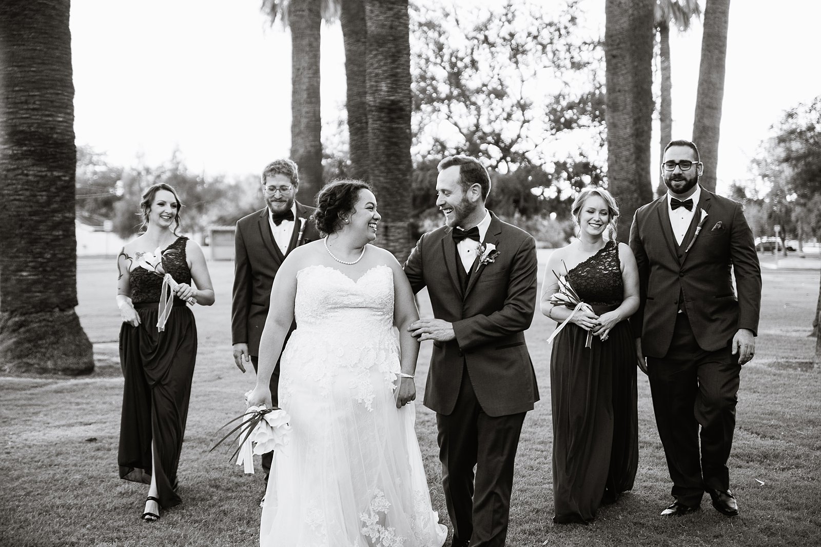 Bridal party laughing together at Encanto Park wedding by Phoenix wedding photographer PMA Photography.