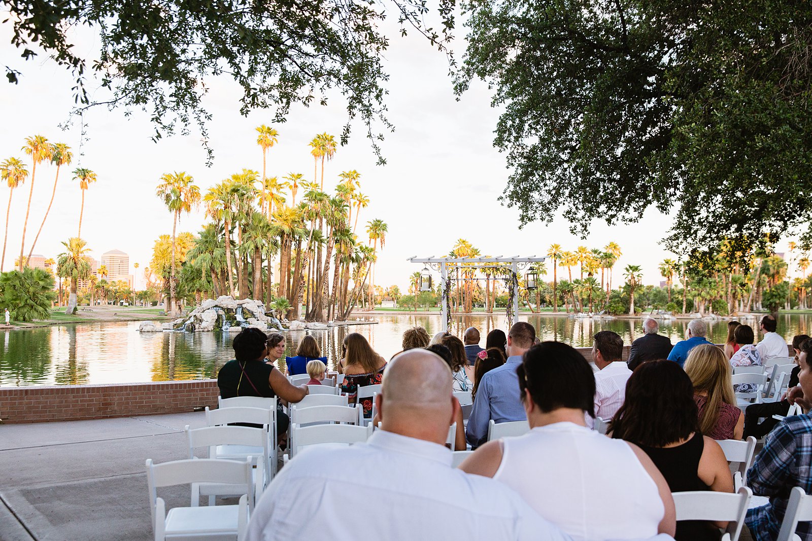 Wedding ceremony at Encanto Park by Arizona wedding photographer PMA Photography.