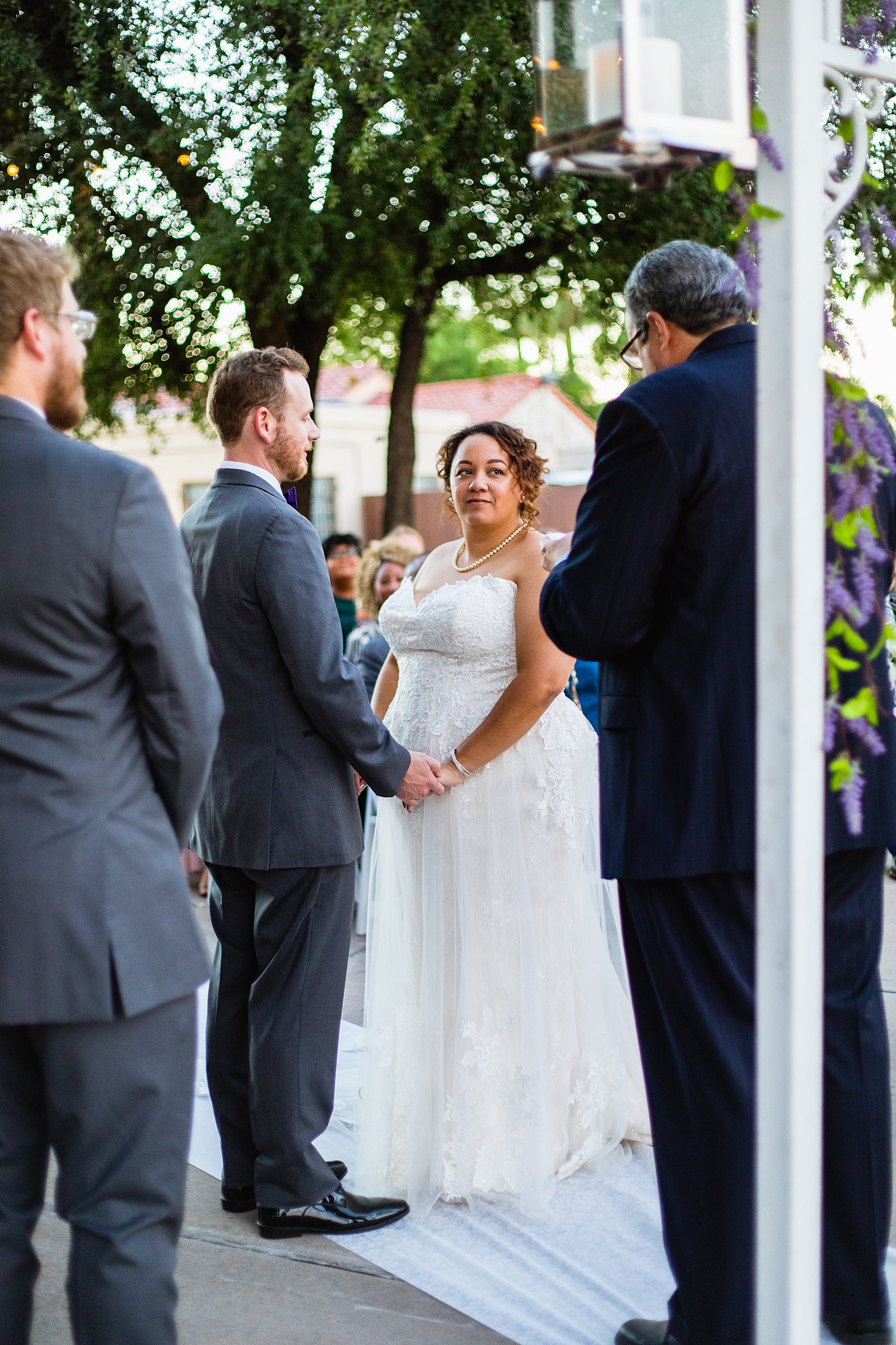 Bride and groom togethering during Encanto Park wedding ceremony by Phoenix wedding photographer PMA Photography.