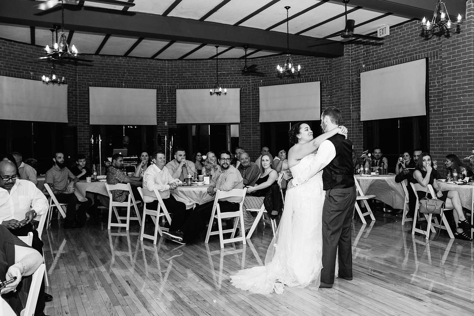 Bride and groom sharing first dance at their Encanto Park wedding reception by Arizona wedding photographer PMA Photography.
