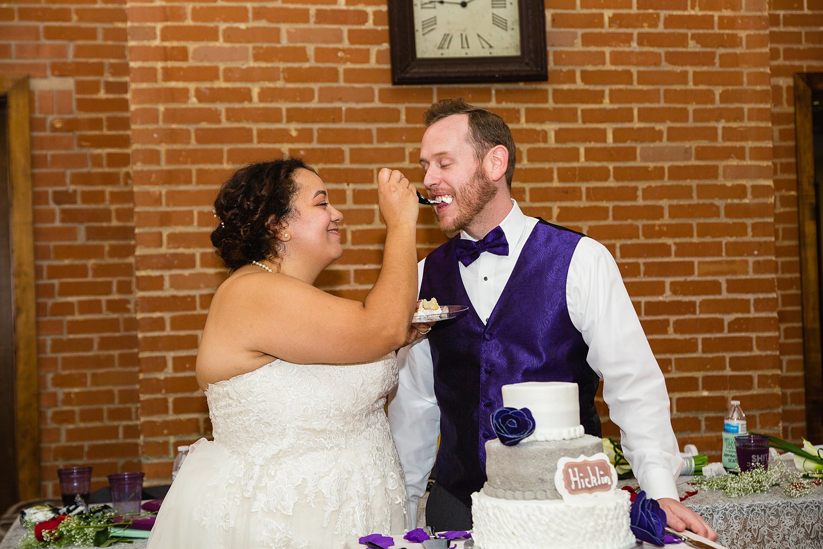 Bride and groom cutting their wedding cake at their Encanto Park wedding reception by Arizona wedding photographer PMA Photography.