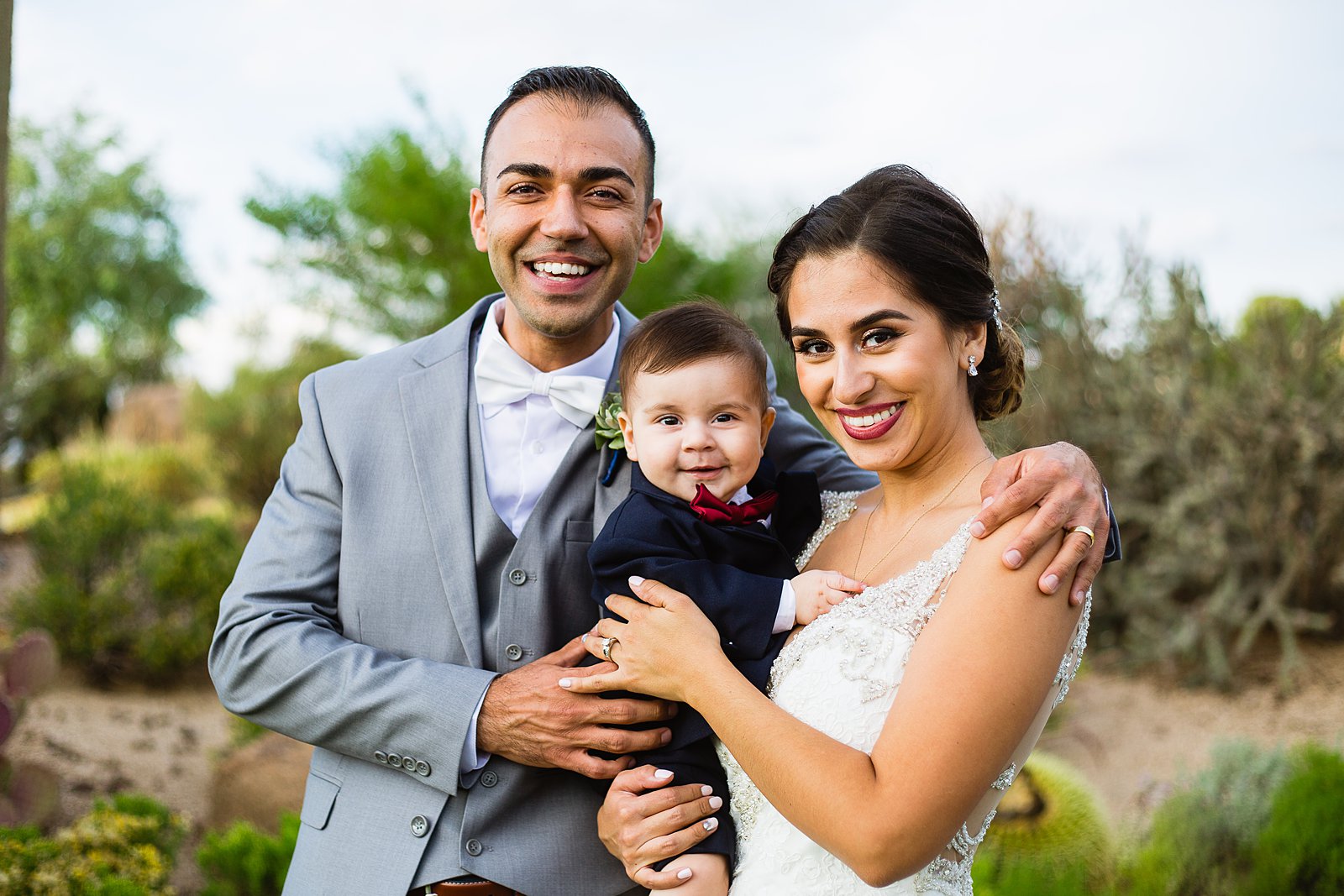 Bride and groom with their son at their Troon North wedding by Arizona wedding photographer PMA Photography.