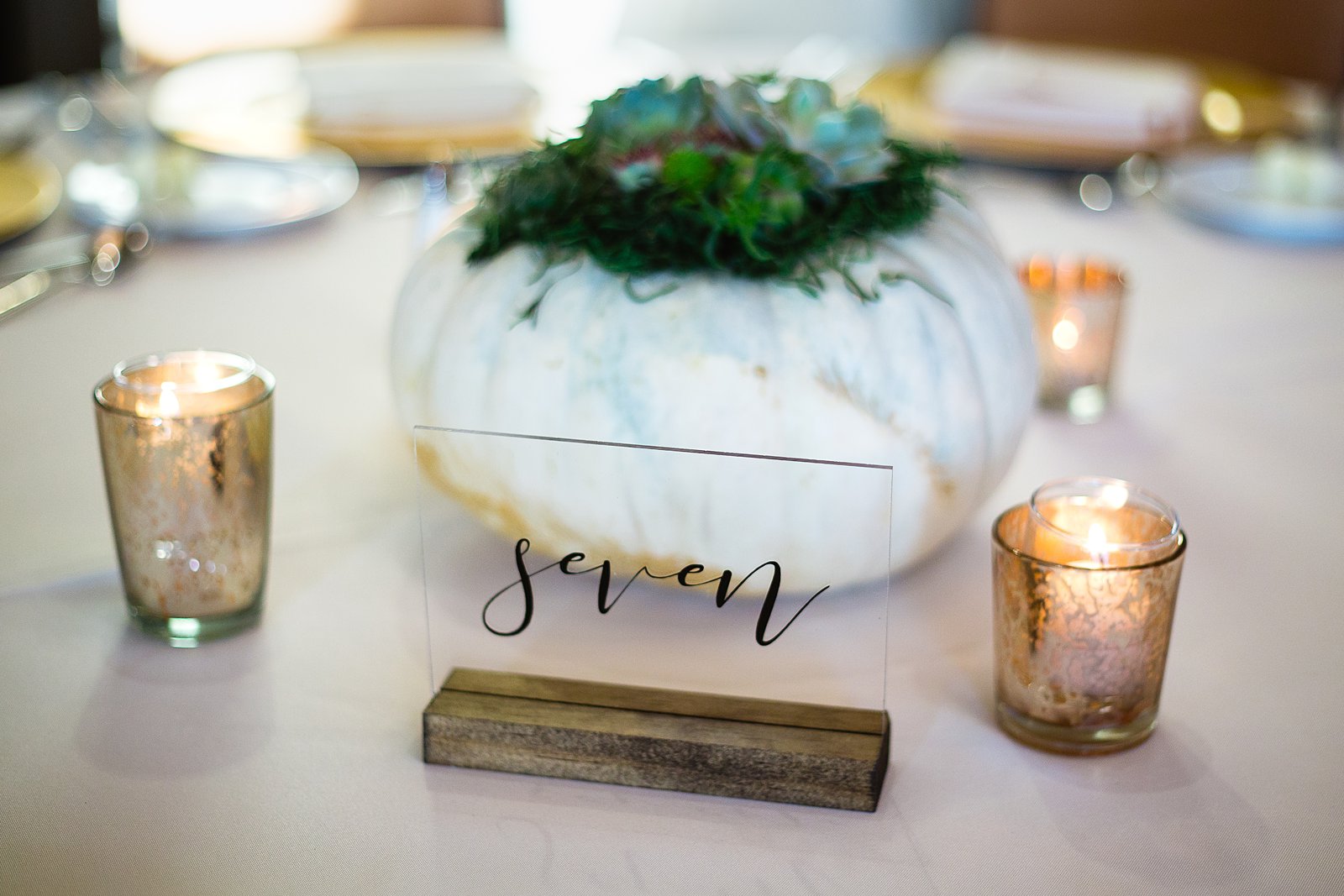Modern fall white pumpkin centerpieces at Troon North wedding reception by Scottsdale wedding photographer PMA Photography.