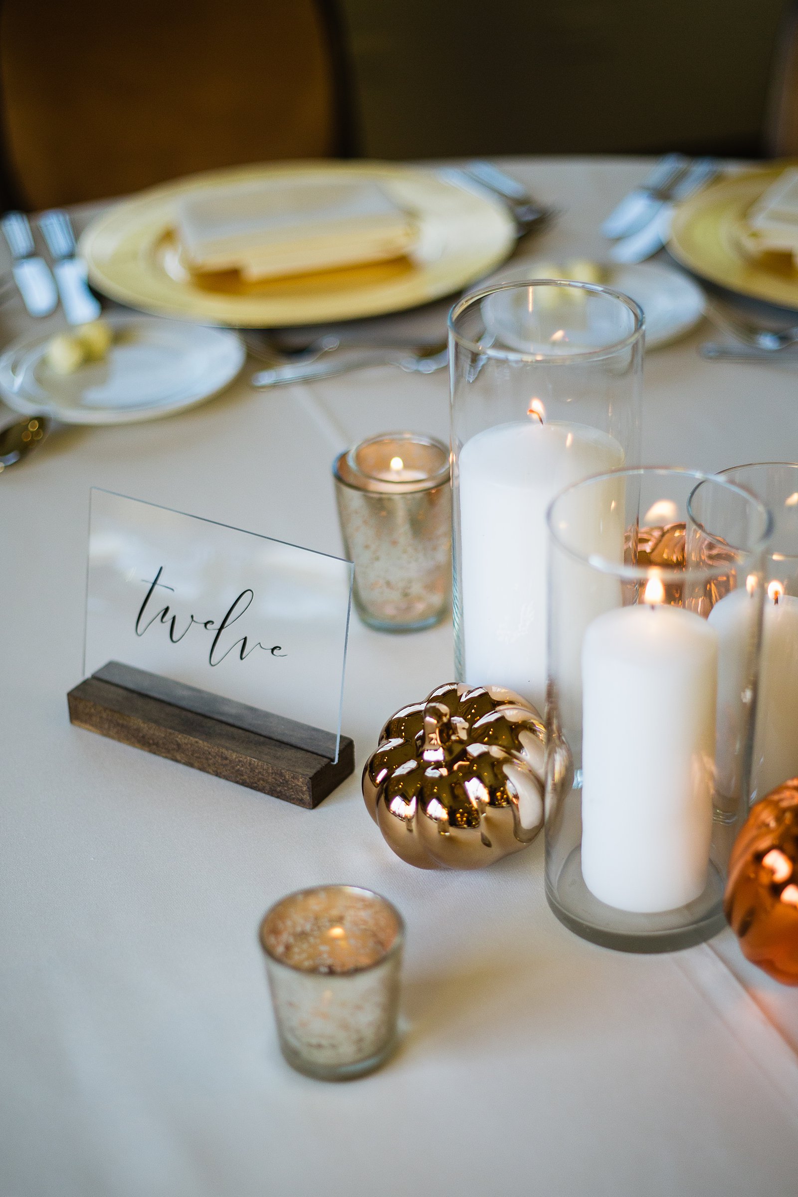 Fall pumpkin and candle centerpieces at Troon North wedding reception by Scottsdale wedding photographer PMA Photography.