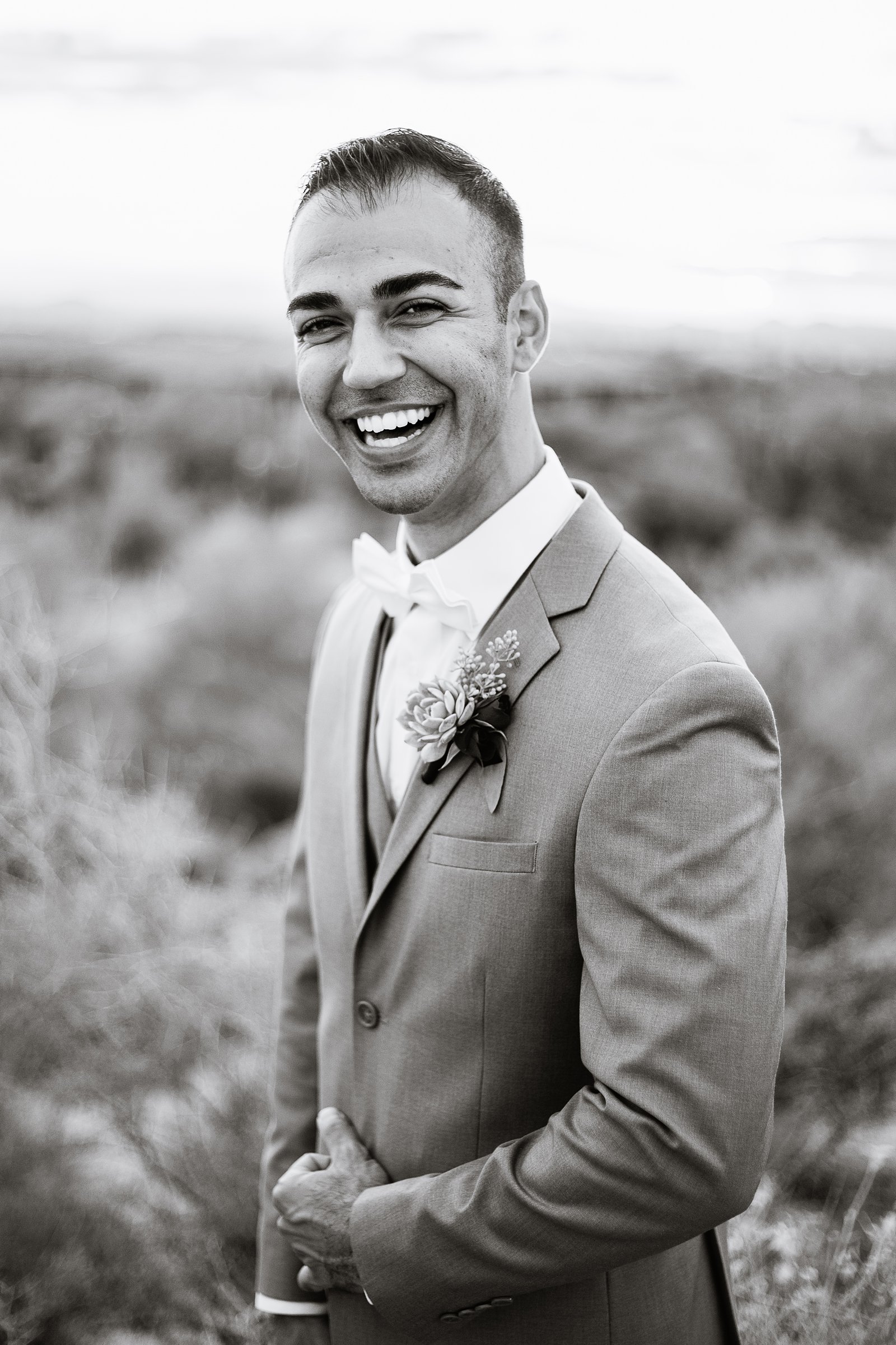 Groom laughing on his wedding day by PMA Photography.