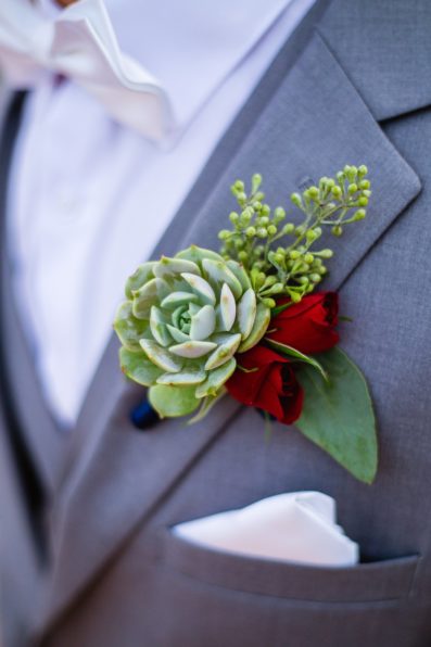 Groom's succulent and red rose boutonniere by PMA Photography.