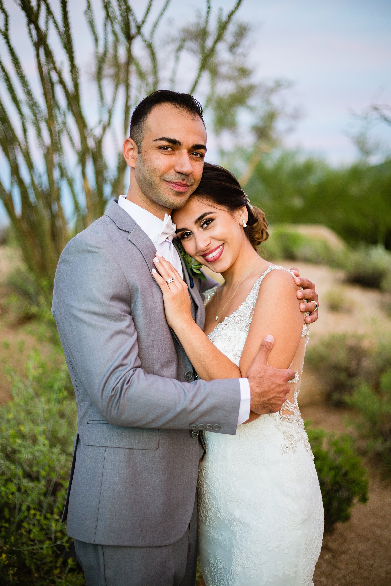 Bride and groom pose for their Troon North wedding by Scottsdale wedding photographer PMA Photography.