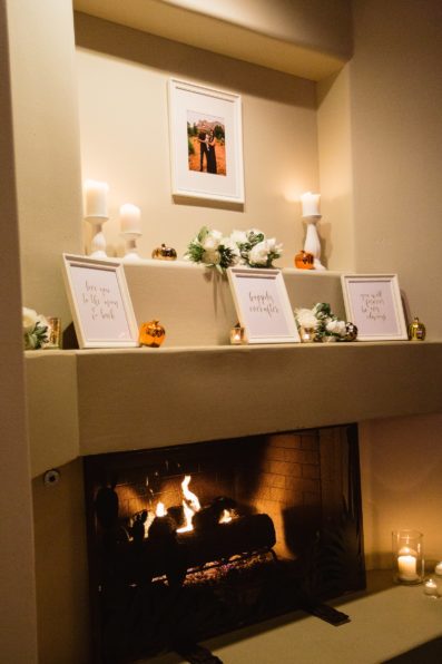 Engagement photo and quotes on a fireplace for reception decorations at Troon North wedding reception by Scottsdale wedding photographer PMA Photography.