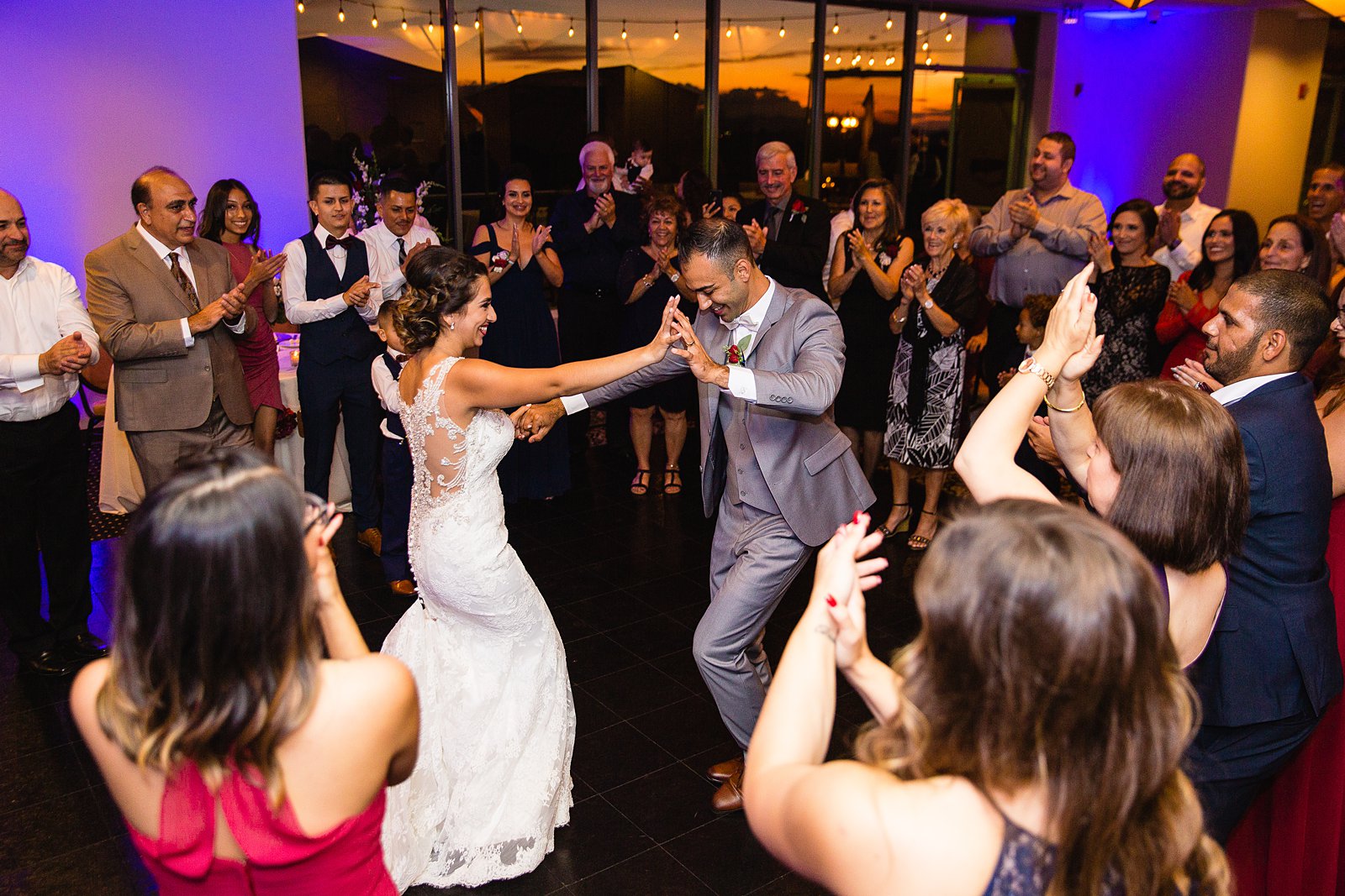 Bride dancing with guests at Troon North wedding reception by Scottsdale wedding photographer PMA Photography