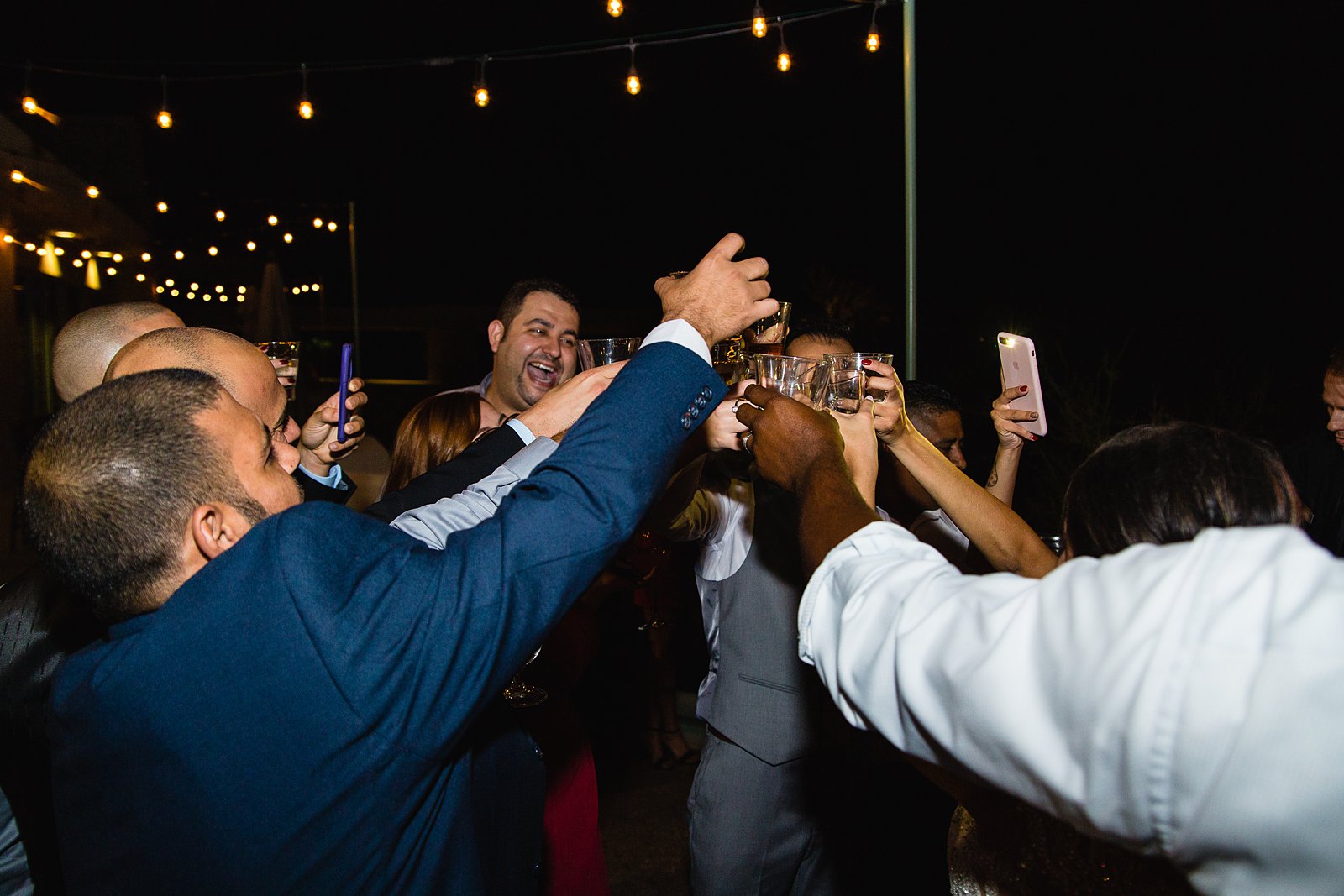 Bride and groom share a shot with wedding guests by PMA Photography.
