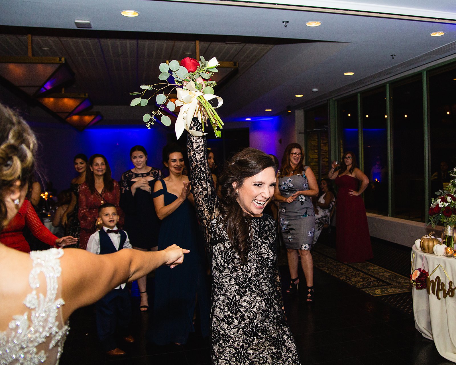 Bouquet toss at Troon North wedding reception by Scottsdale wedding photographer PMA Photography.