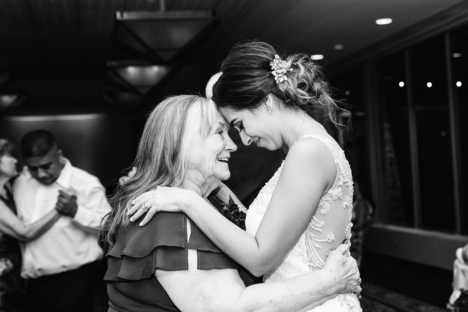 Bride shares a dance with her grandmother at Troon North wedding reception by Scottsdale wedding photographer PMA Photography.