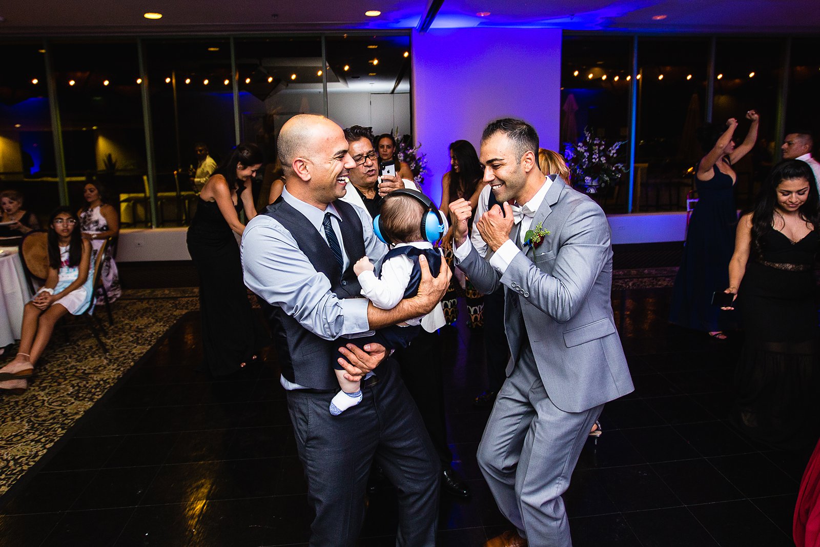 Groom dancing with son and guests at Troon North wedding reception by Scottsdale wedding photographer PMA Photography
