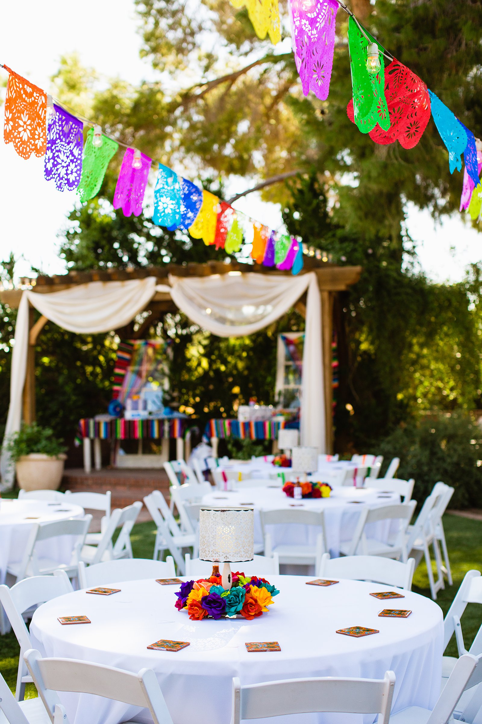 Colorful fiesta reception decorations at The Farmhouse at Schnepf Farms wedding reception by Queen Creek wedding photographer PMA Photography.