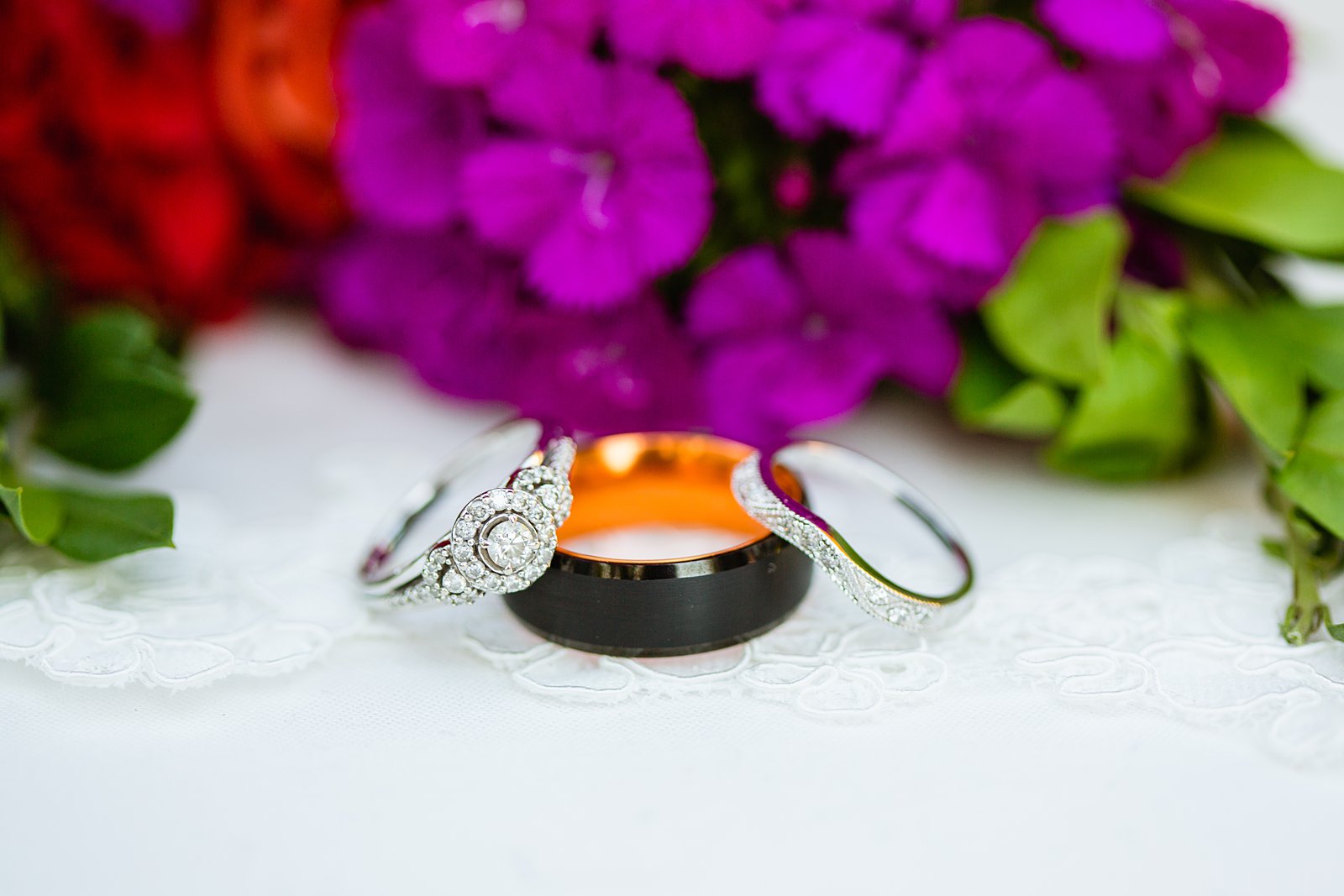 Bride and grooms wedding bands with groom's alternative black and orange Manly Bands weding ing by PMA Photography.