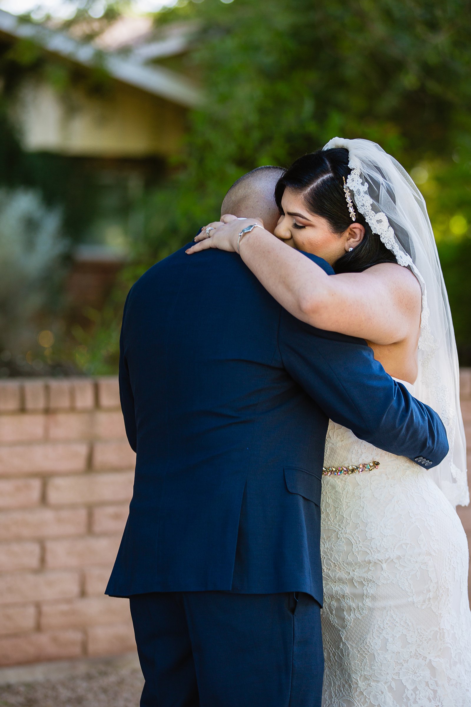Bride and groom share an intimate moment during their first look at The Farmhouse at Schnepf Farms by Arizona wedding photographer PMA Photography.