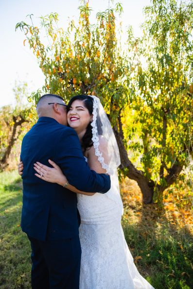 Bride and groom laughing together during their The Farmhouse at Schnepf Farms wedding by Queen Creek wedding photographer PMA Photography.