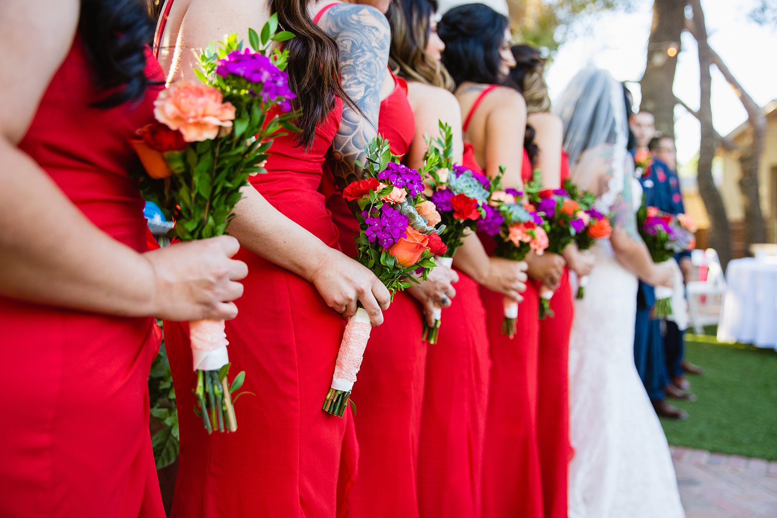 Fiesta bridal party bouquets and red dresses by PMA Photography.