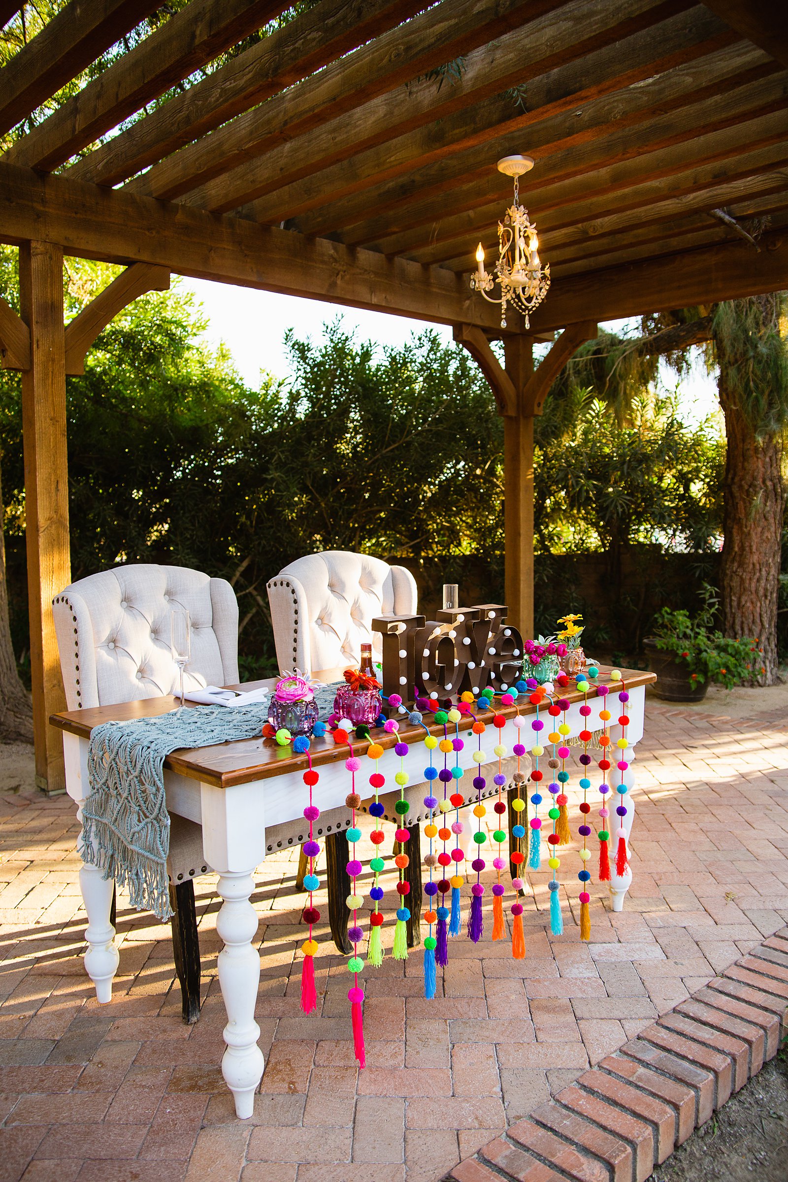 Colorful fiesta sweetheart table at The Farmhouse at Schnepf Farms wedding reception by Arizona wedding photographer PMA Photography.
