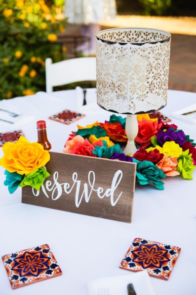 Colorful, fiesta centerpieces at The Farmhouse at Schnepf Farms wedding reception by Queen Creek wedding photographer PMA Photography.