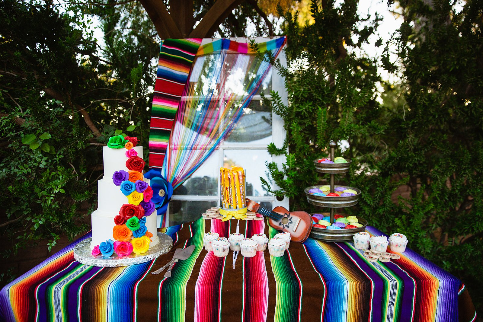 Colorful fiesta cake table at The Farmhouse at Schnepf Farms wedding reception by Arizona wedding photographer PMA Photography.