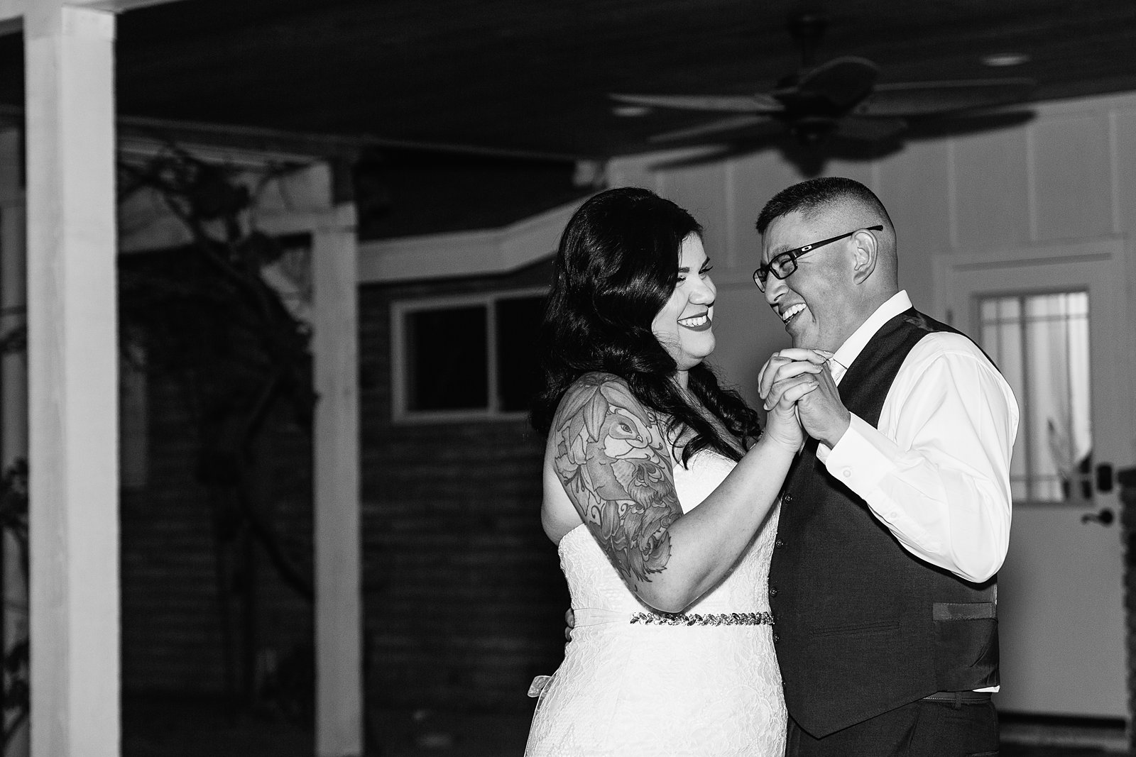 Bride and groom sharing first dance at their The Farmhouse at Schnepf Farms wedding reception by Arizona wedding photographer PMA Photography.