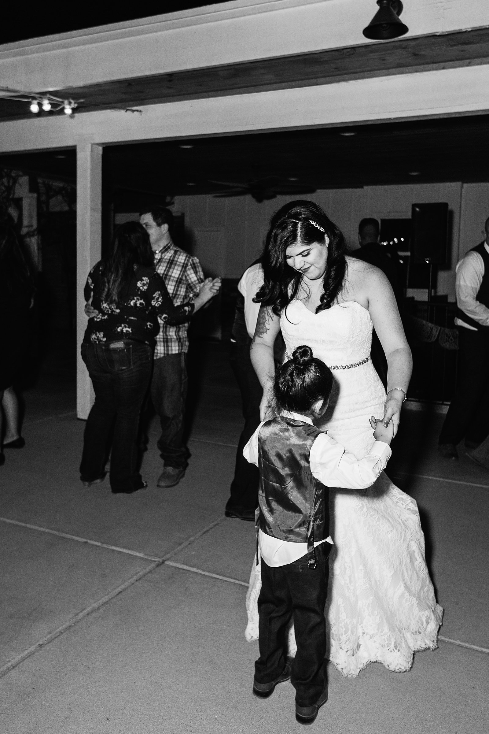 Bride dancing with son at The Farmhouse at Schnepf Farms wedding reception by Queen Creek wedding photographer PMA Photography