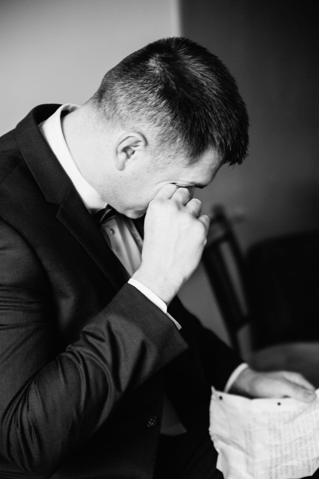 Groom crying while reading a letter from his bride before the ceremony by Arizona wedding photographer PMA Photography.