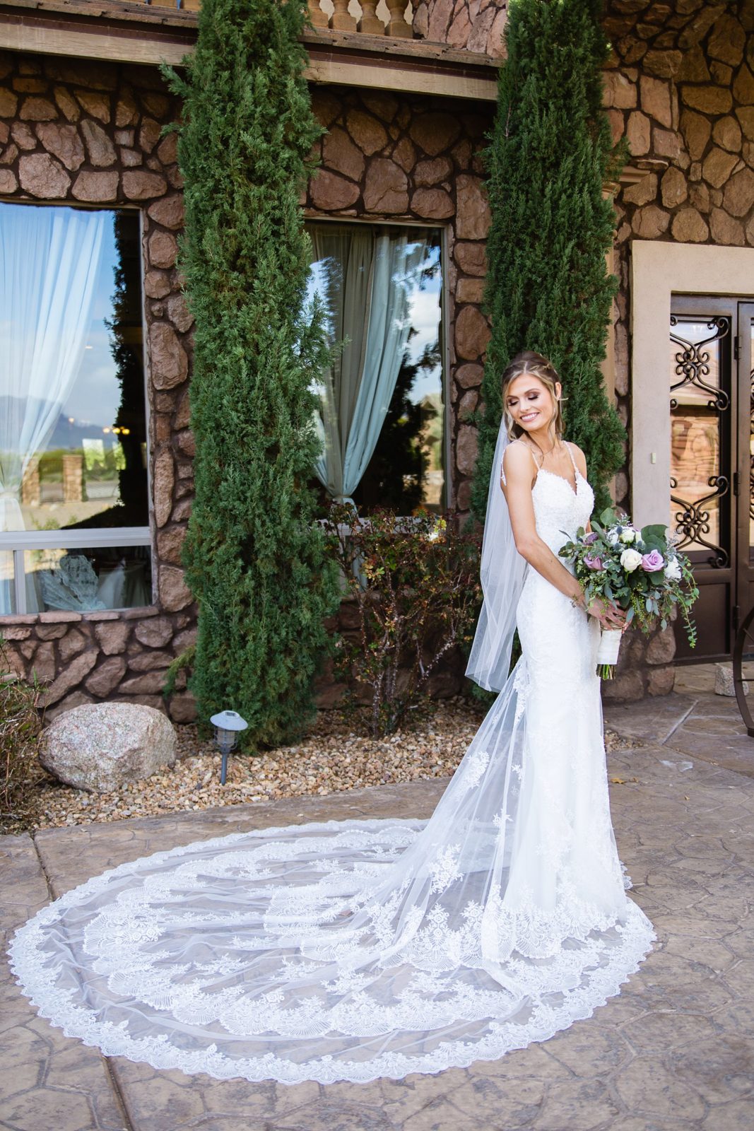Bride in her romantic mermaid style wedding dress with beautiful lace train by Mesa wedding photographer PMA Photography.