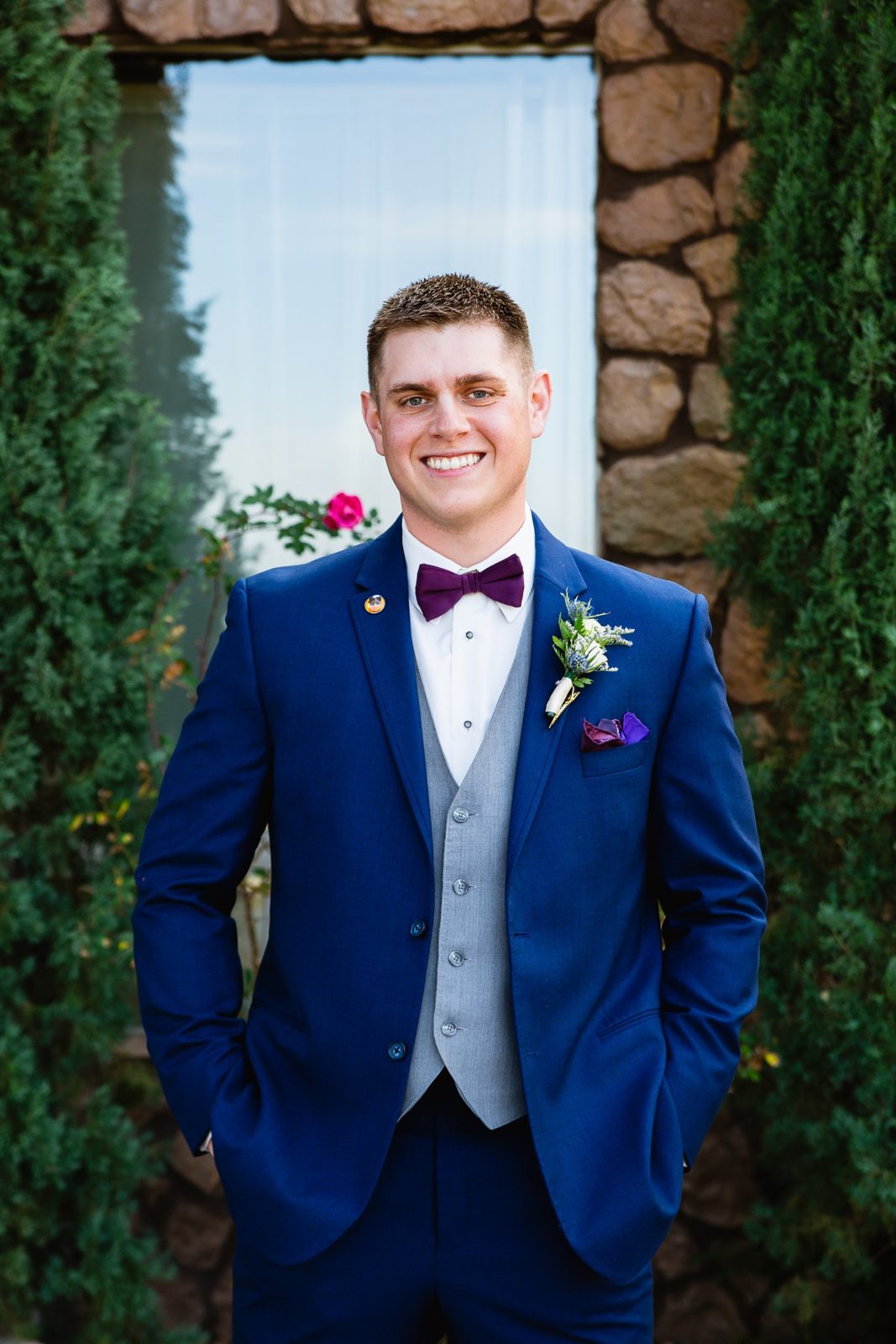 Groom's navy suit with purple and grey accents by Arizona wedding photographer PMA Photography.