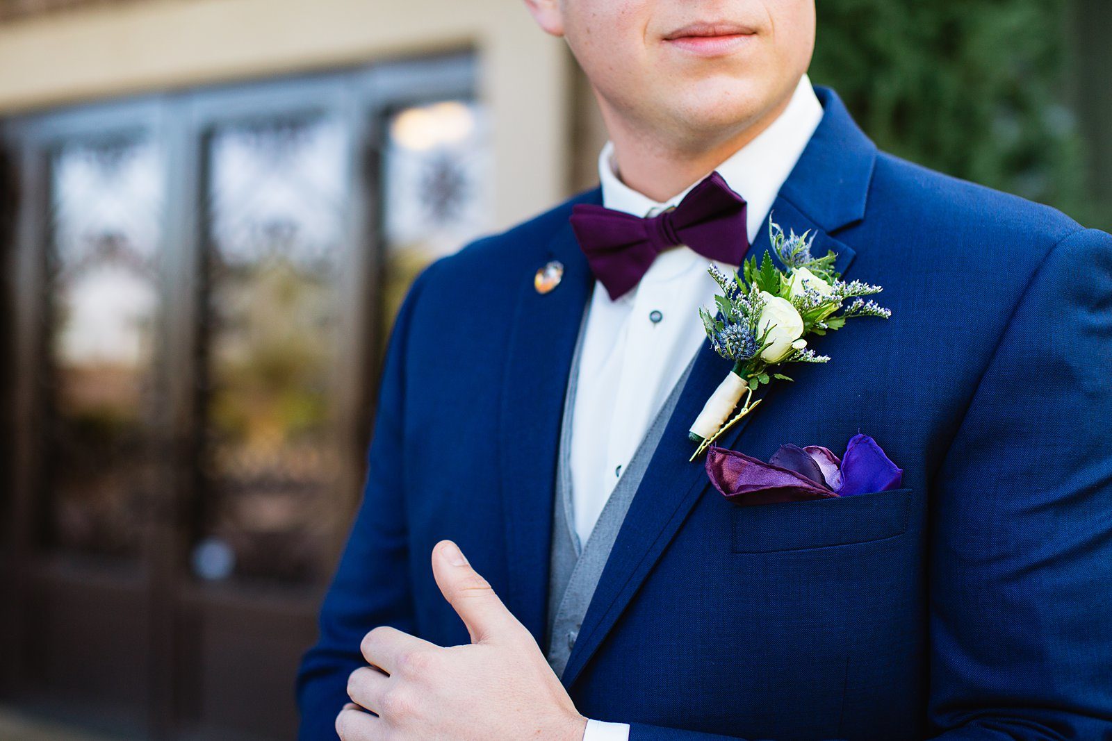 Groom's outfit details of a navy suit with purple accents by Arizona wedding photographer PMA Photography.