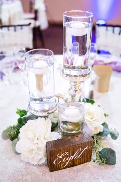 Simple romantic rustic floating candle and wood table number reception centerpiece at Superstition Manor by wedding photographer PMA Photography.